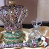 Small Kingdom Warrior Crown set $175. Open wire frame Crown trimmed in camouflage ribbon and jeweled; Base of emerald green Lame' and gold trimmings; 2' Warrior Designer Scepter wrapped in camouflage ribbon and elaborately jeweled, and Orb will be decorated to match.